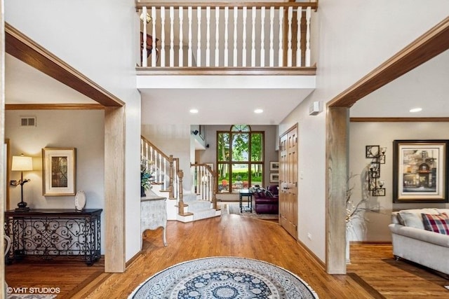 3104 Royal Fox Dr, Saint Charles, IL 60174 - entryway with stairway, wood finished floors, a towering ceiling, and ornamental molding
