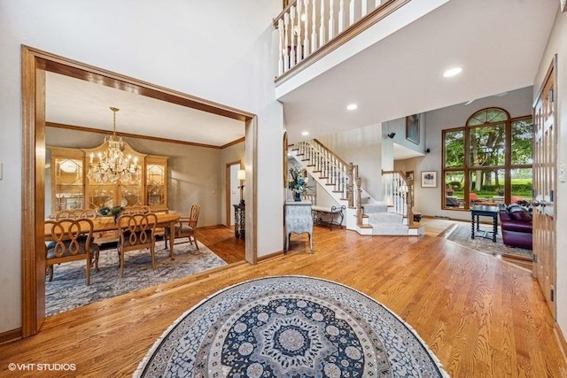 3104 Royal Fox Dr, Saint Charles, IL 60174 - entryway featuring stairs, wood finished floors, a chandelier, a high ceiling, and ornamental molding