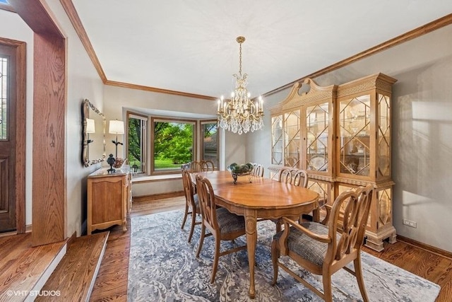 3104 Royal Fox Dr, Saint Charles, IL 60174 - dining space with ornamental molding, a chandelier, and wood finished floors