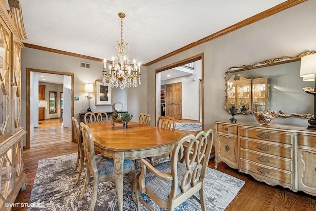 3104 Royal Fox Dr, Saint Charles, IL 60174 - dining area with a chandelier, dark wood-style floors, and ornamental molding