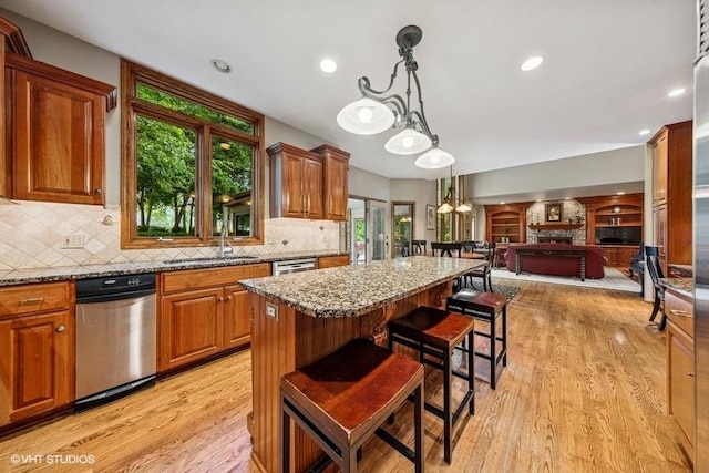 3104 Royal Fox Dr, Saint Charles, IL 60174 - kitchen with open floor plan, light stone countertops, a breakfast bar, a center island, and recessed lighting
