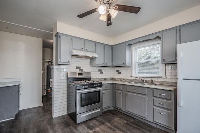 14909 Langley Ave, Dolton, IL 60419 - kitchen with gray cabinetry, freestanding refrigerator, stainless steel gas range, a sink, and under cabinet range hood