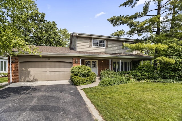 1145 Wincanton Dr, Deerfield, IL 60015 - traditional home featuring an attached garage, driveway, a front lawn, and brick siding
