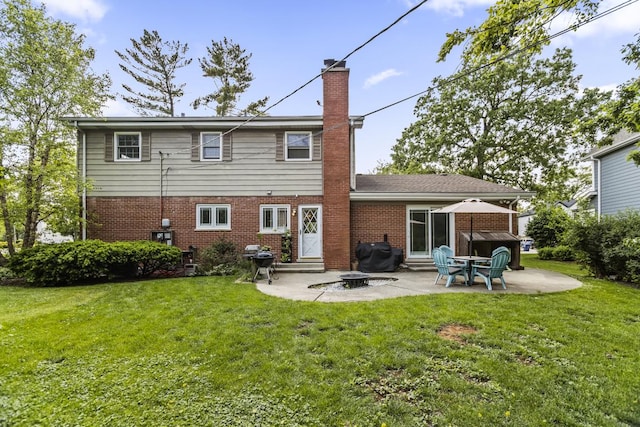 1145 Wincanton Dr, Deerfield, IL 60015 - rear view of house featuring entry steps, a chimney, brick siding, a patio area, and a lawn