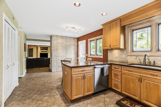 1145 Wincanton Dr, Deerfield, IL 60015 - kitchen featuring stainless steel dishwasher, a peninsula, dark stone counters, tasteful backsplash, and tile patterned flooring