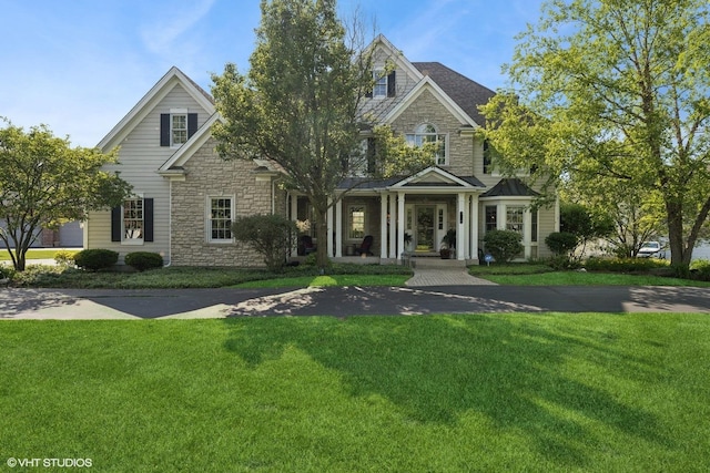 9520 Nicklaus Ln, Crystal Lake, IL 60014 - view of front of home featuring stone siding and a front lawn