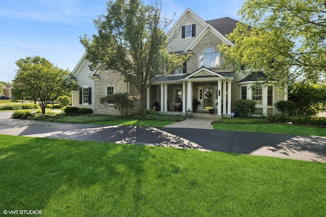 9520 Nicklaus Ln, Crystal Lake, IL 60014 - view of front facade featuring stone siding, a front yard, and a standing seam roof