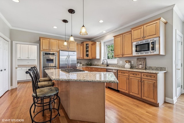 9520 Nicklaus Ln, Crystal Lake, IL 60014 - kitchen with built in appliances, a kitchen breakfast bar, crown molding, a kitchen island, and light wood-style flooring