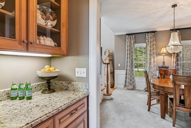 9520 Nicklaus Ln, Crystal Lake, IL 60014 - dining space featuring light carpet, a chandelier, a wainscoted wall, and ornamental molding