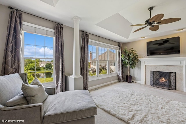 9520 Nicklaus Ln, Crystal Lake, IL 60014 - carpeted living area with a raised ceiling, a tile fireplace, ornate columns, and a ceiling fan
