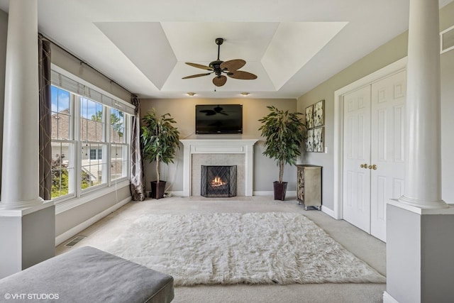 9520 Nicklaus Ln, Crystal Lake, IL 60014 - carpeted living area featuring a tray ceiling, ceiling fan, a high end fireplace, and decorative columns