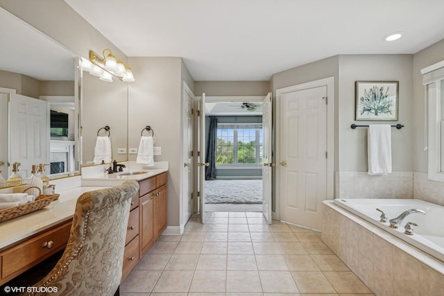 9520 Nicklaus Ln, Crystal Lake, IL 60014 - bathroom featuring vanity, a garden tub, ceiling fan, a fireplace, and tile patterned floors