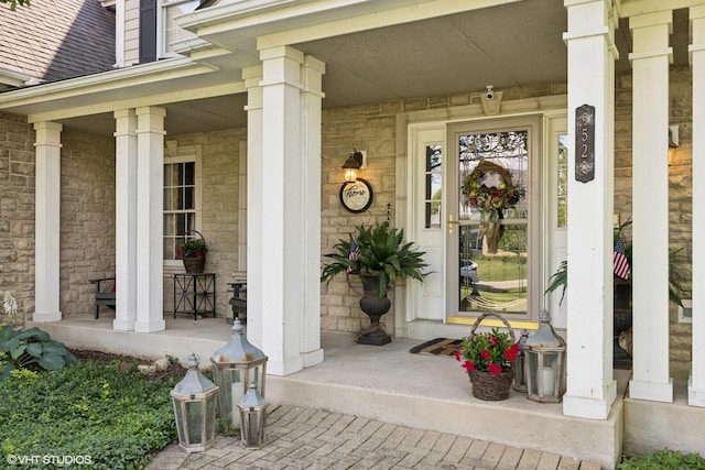 9520 Nicklaus Ln, Crystal Lake, IL 60014 - entrance to property featuring a porch, a security system, stone siding, and a shingled roof