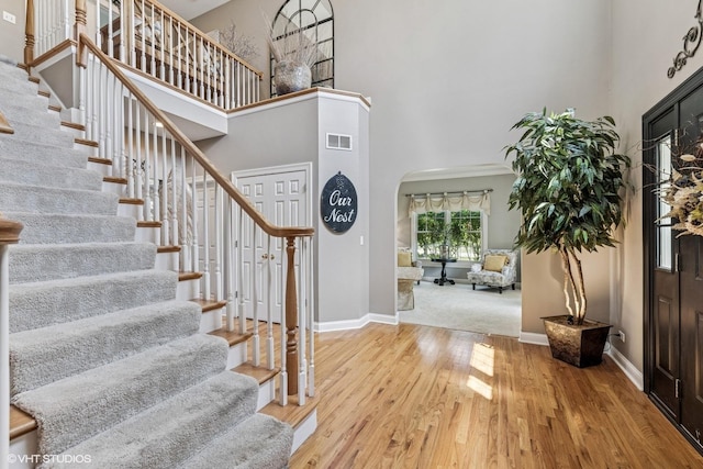 9520 Nicklaus Ln, Crystal Lake, IL 60014 - entrance foyer with a towering ceiling, stairway, wood finished floors, and arched walkways