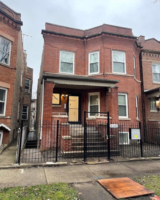 6141 S Eberhart Ave, Chicago, IL 60637 - view of property featuring a fenced front yard, brick siding, and covered porch