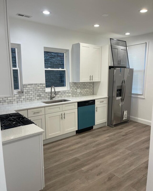 6141 S Eberhart Ave, Chicago, IL 60637 - kitchen featuring dishwashing machine, stainless steel refrigerator with ice dispenser, a sink, light wood-style floors, and white cabinets