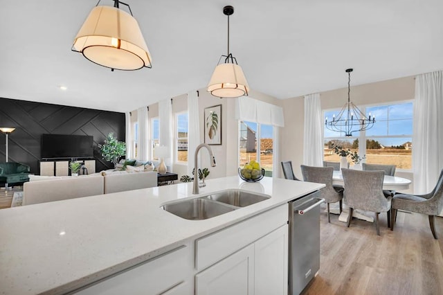 298 Astor Ct, Elgin, IL 60124 - kitchen featuring stainless steel dishwasher, healthy amount of natural light, white cabinets, and a chandelier