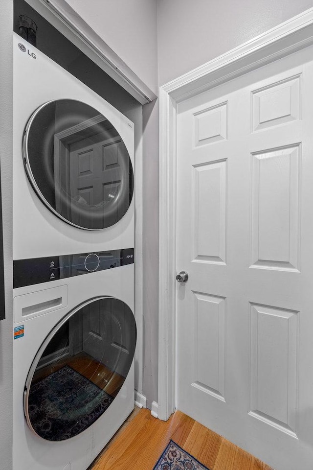 3405 N Harding Ave Unit 1, Chicago, IL 60618 - laundry room featuring estacked washer and dryer and light wood-style flooring