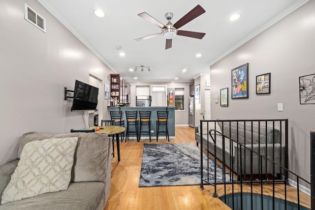 3405 N Harding Ave Unit 1, Chicago, IL 60618 - living room featuring ornamental molding, ceiling fan, recessed lighting, light wood-type flooring, and baseboards