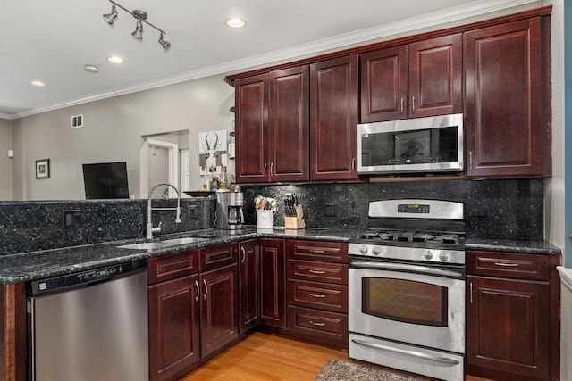 3405 N Harding Ave Unit 1, Chicago, IL 60618 - kitchen with appliances with stainless steel finishes, a sink, ornamental molding, tasteful backsplash, and light wood finished floors