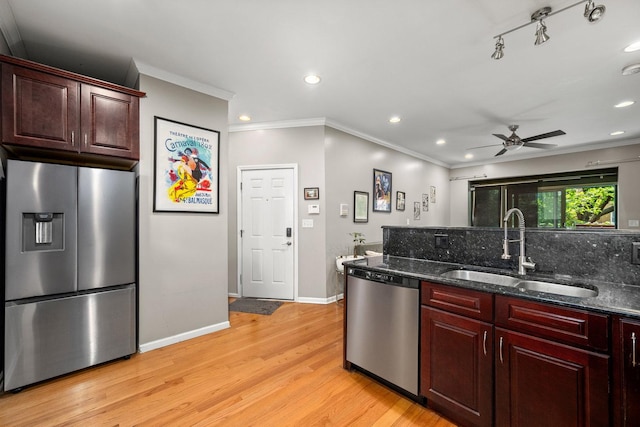 3405 N Harding Ave Unit 1, Chicago, IL 60618 - kitchen with stainless steel appliances, a sink, light wood-style floors, ornamental molding, and baseboards