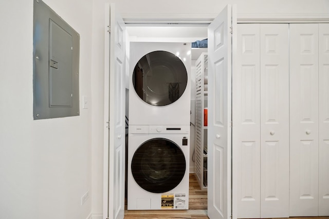 1443 N Mohawk St Unit 1, Chicago, IL 60610 - laundry area with stacked washer / dryer, electric panel, and wood finished floors