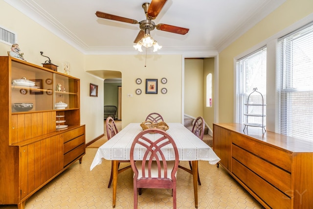 3730 Wenonah Ave, Berwyn, IL 60402 - dining area featuring arched walkways, crown molding, and ceiling fan
