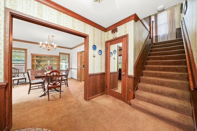 3218 Wenonah Ave, Berwyn, IL 60402 - stairway with wallpapered walls, crown molding, carpet, a wainscoted wall, and a chandelier