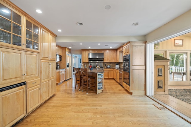 948A Shetland Dr, Frankfort, IL 60423 - kitchen featuring a kitchen breakfast bar, extractor fan, light wood finished floors, light brown cabinetry, and a center island