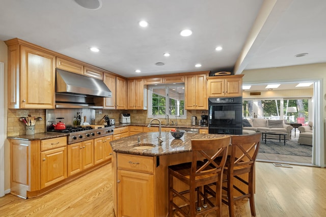948A Shetland Dr, Frankfort, IL 60423 - kitchen with exhaust hood, stainless steel gas stovetop, light wood-style flooring, dark stone counters, and recessed lighting