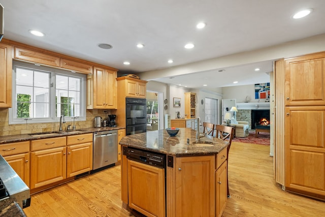 948A Shetland Dr, Frankfort, IL 60423 - kitchen with stainless steel dishwasher, a kitchen island, light wood-style floors, dark stone counters, and recessed lighting
