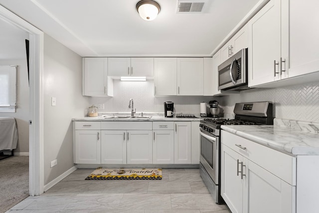 417 Dellwood Ave, Lockport, IL 60441 - kitchen with stainless steel appliances, backsplash, light countertops, and white cabinets