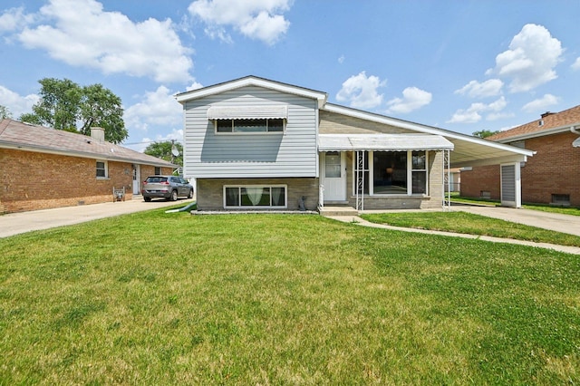 1127 Herbert Ave, Berkeley, IL 60163 - view of front facade with concrete driveway, a front lawn, and an attached carport