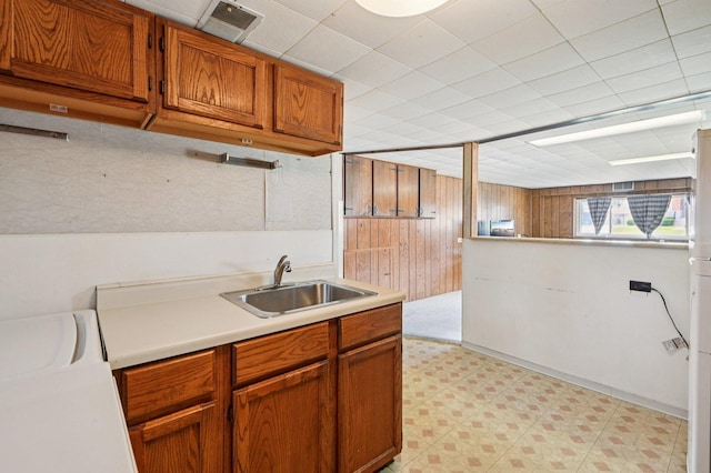 1127 Herbert Ave, Berkeley, IL 60163 - kitchen featuring light floors, light countertops, brown cabinets, and wood walls