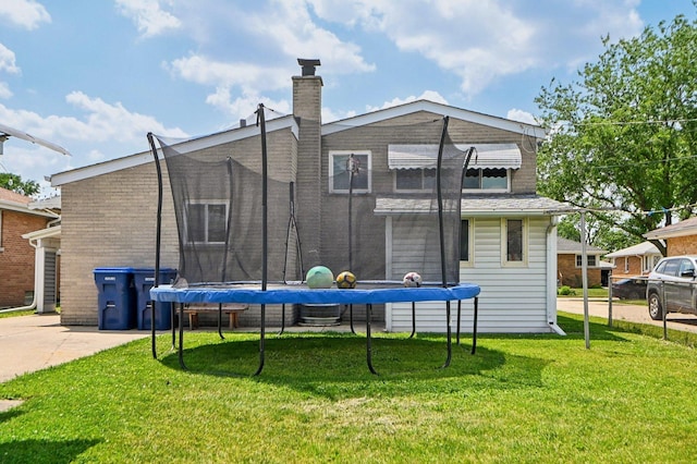 1127 Herbert Ave, Berkeley, IL 60163 - back of property featuring a trampoline, a yard, and a chimney