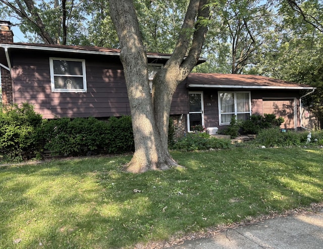 136 Larchmont Way, Bolingbrook, IL 60440 - split level home with a chimney, a front yard, an attached garage, and brick siding