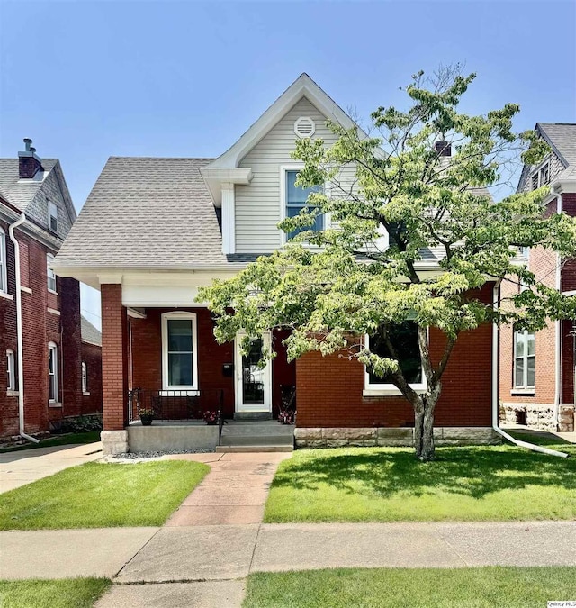 732 S 13th, Quincy, IL 62301 - view of front facade featuring a front yard, brick siding, and roof with shingles