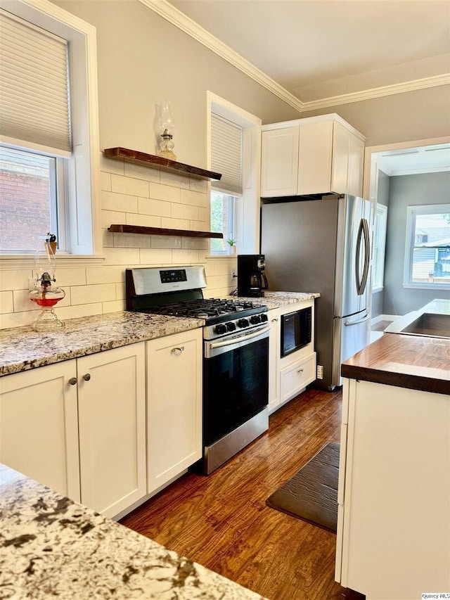 732 S 13th, Quincy, IL 62301 - kitchen with stainless steel appliances, white cabinets, dark wood-type flooring, backsplash, and crown molding