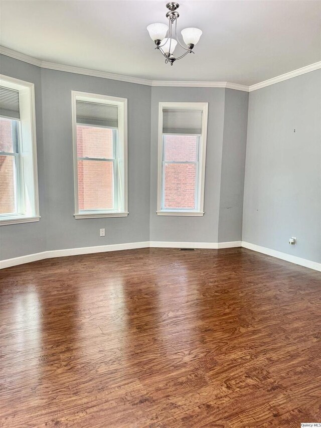 732 S 13th, Quincy, IL 62301 - unfurnished room featuring a chandelier, wood finished floors, ornamental molding, and baseboards