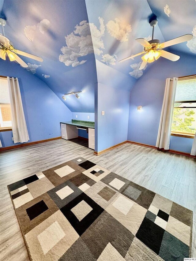 732 S 13th, Quincy, IL 62301 - unfurnished living room with ceiling fan, vaulted ceiling, baseboards, and wood finished floors