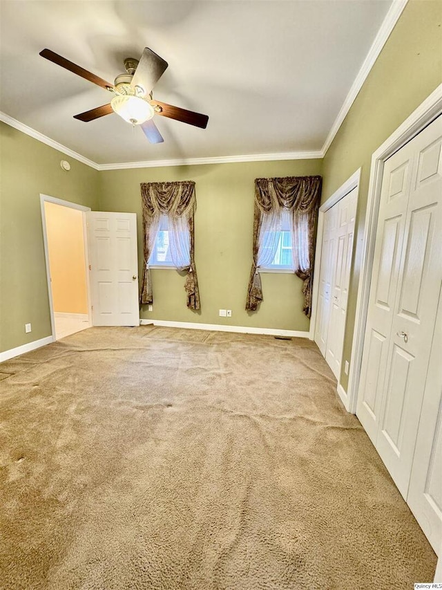 732 S 13th, Quincy, IL 62301 - unfurnished bedroom featuring ornamental molding, baseboards, multiple windows, and two closets
