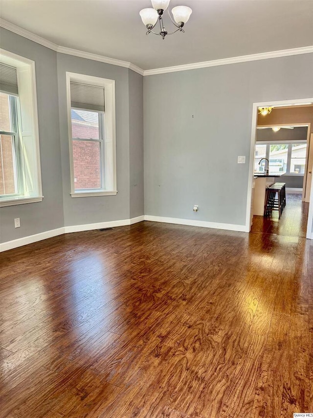 732 S 13th, Quincy, IL 62301 - unfurnished room featuring wood finished floors, a chandelier, ornamental molding, and baseboards