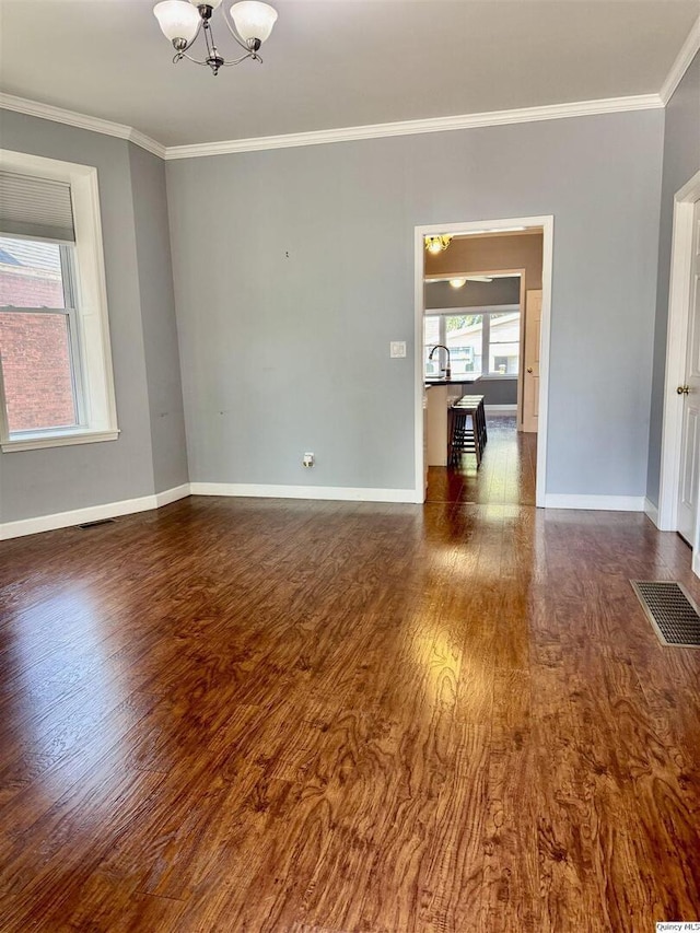732 S 13th, Quincy, IL 62301 - empty room with ornamental molding, a chandelier, wood finished floors, and baseboards