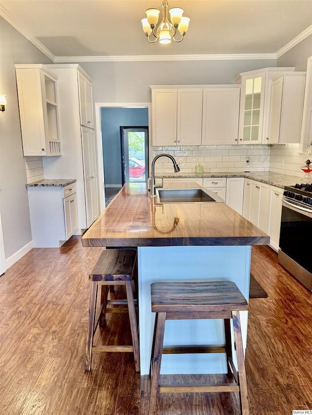732 S 13th, Quincy, IL 62301 - kitchen with stainless steel range with gas stovetop, a sink, open shelves, white cabinets, and ornamental molding