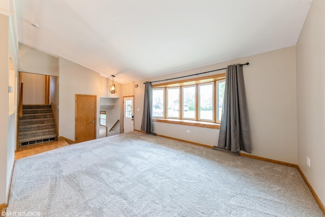 2510 Timber Ln, Lindenhurst, IL 60046 - unfurnished living room featuring vaulted ceiling, carpet floors, and stairway