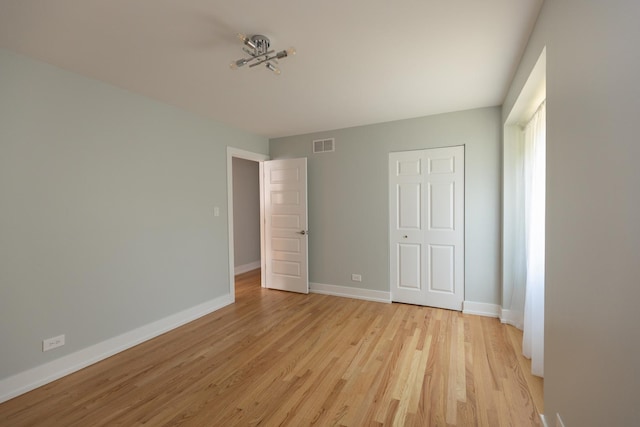 3145 Hillside Ln, Darien, IL 60561 - unfurnished bedroom with light wood-type flooring and baseboards