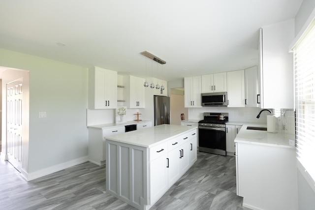 3145 Hillside Ln, Darien, IL 60561 - kitchen with appliances with stainless steel finishes, a kitchen island, light stone counters, and backsplash