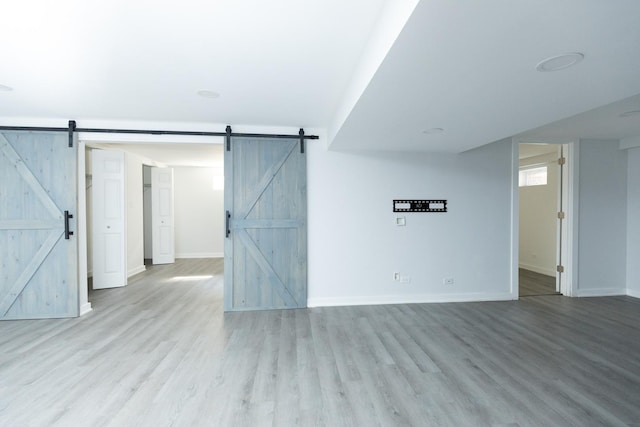 3145 Hillside Ln, Darien, IL 60561 - empty room featuring a barn door and wood finished floors