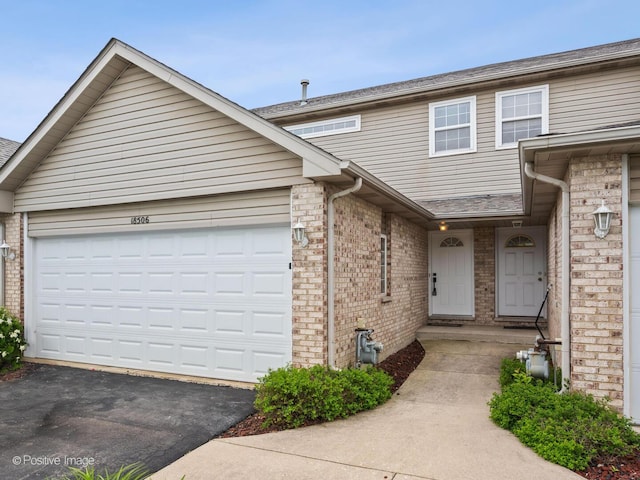 18506 Bellagio Cir, Tinley Park, IL 60477 - multi unit property with driveway, brick siding, and an attached garage