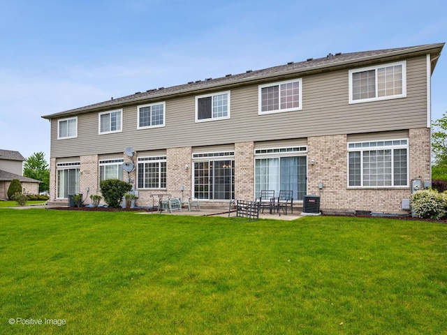 18506 Bellagio Cir, Tinley Park, IL 60477 - rear view of house with brick siding, a patio area, and a yard